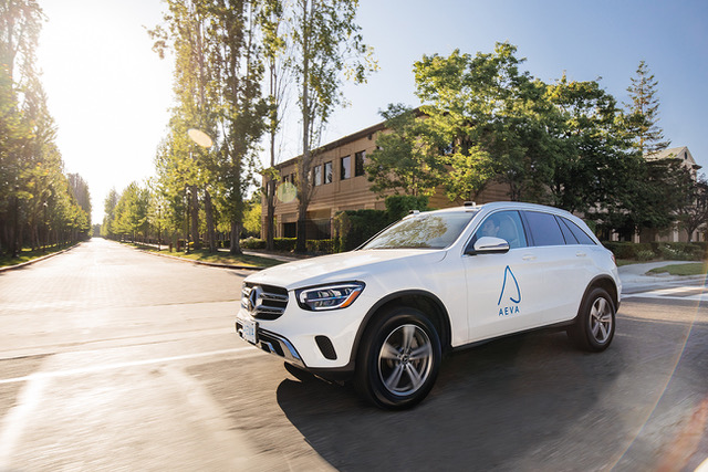 Aeva branded white car on the road at an intersection